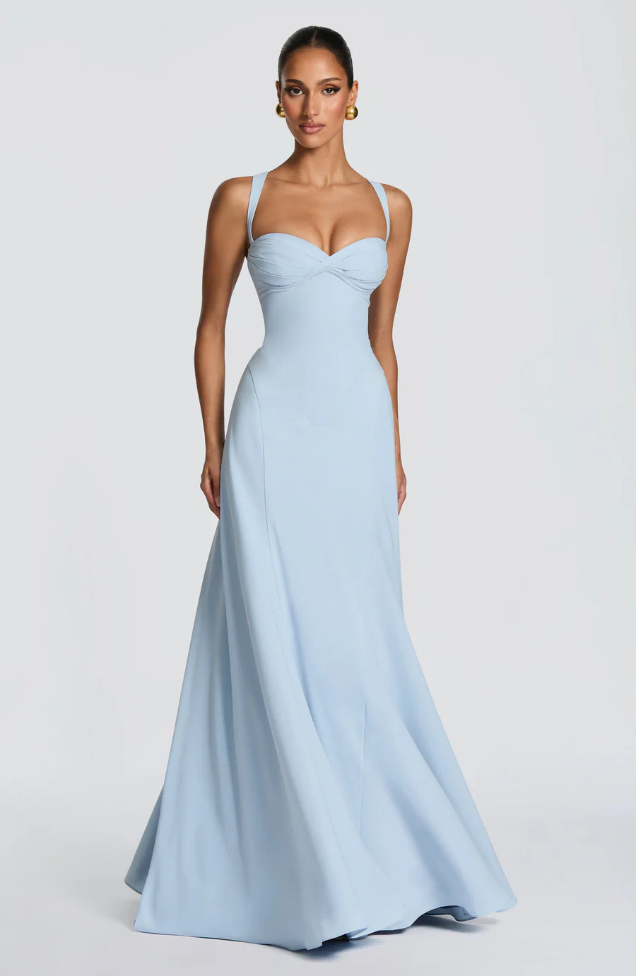Three-quarter front view of light blue corset maxi dress with fitted bodice and flared hem
