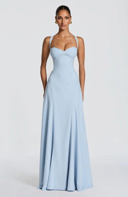Light blue corset maxi dress with sweetheart neckline, wide straps, and flowing floor-length skirt