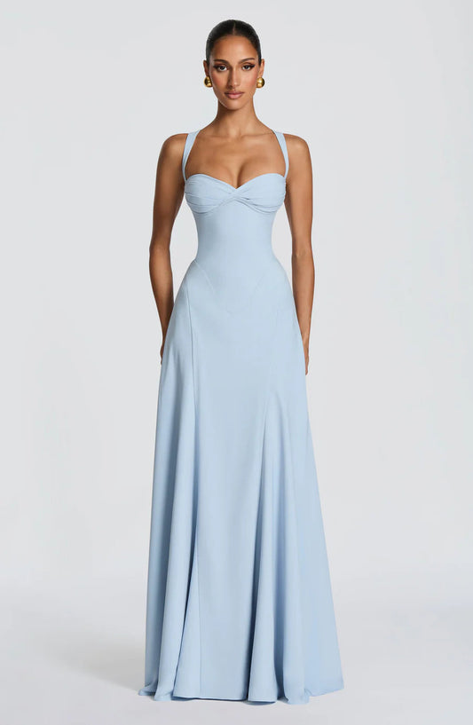 Light blue corset maxi dress with sweetheart neckline, wide straps, and flowing floor-length skirt