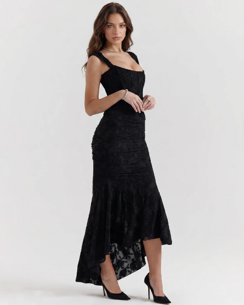 Side view black corset midi dress with textured floral fabric, fitted waist and dipped hem