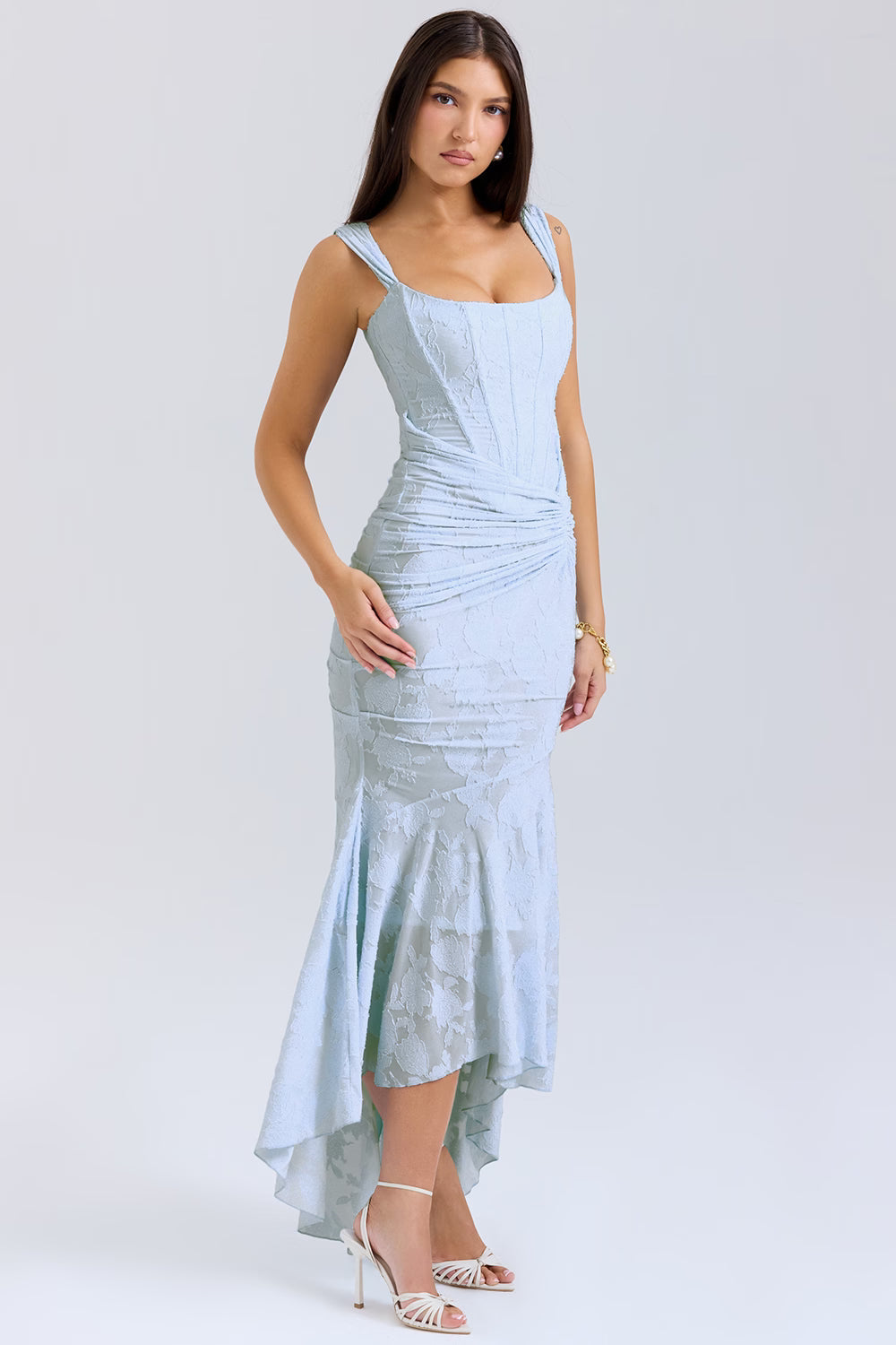 Three-quarter front view of light blue floral jacquard corset midi dress with asymmetrical high-low skirt