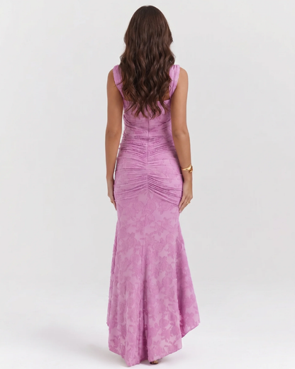 Back view of pink corset midi dress showing fitted silhouette, ruched back detail and high-low hemline