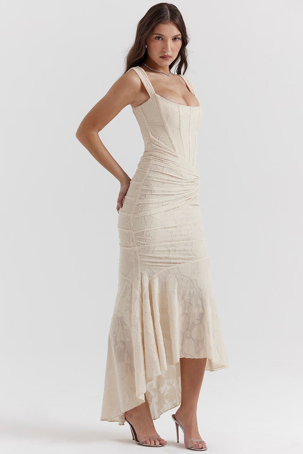 Side view white corset midi dress with structured bodice seams, ruched hip detail and dipped hem