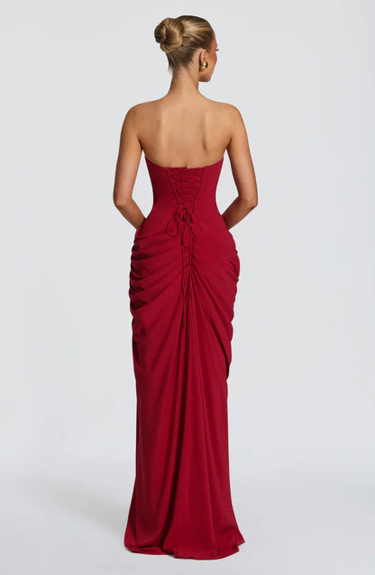 Back view of red strapless maxi dress with lace-up corset back and gathered ruched skirt