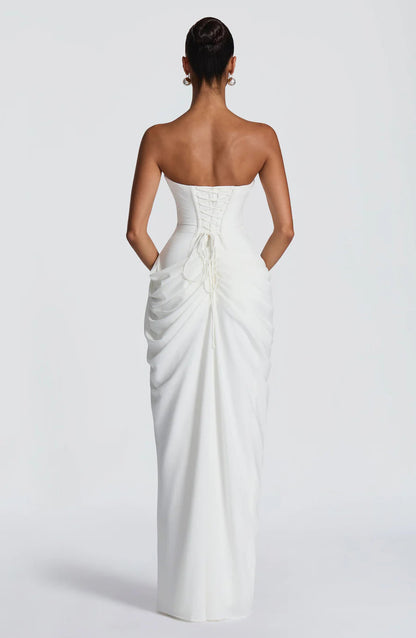 Full back close-up of white ruched maxi dress with lace-up ties and center back seam