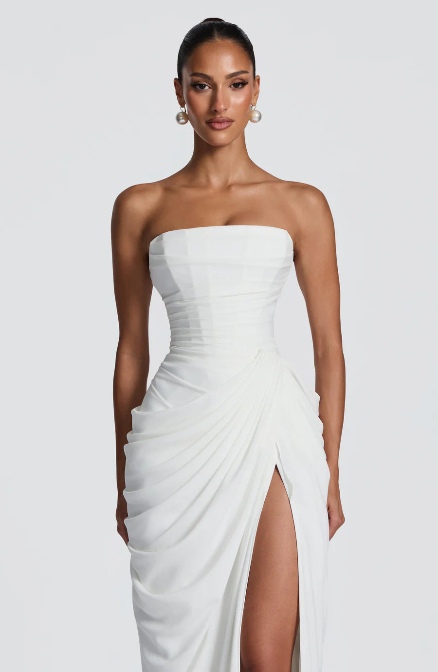 Front bodice close-up of white strapless maxi dress with smooth straight neckline and ruching