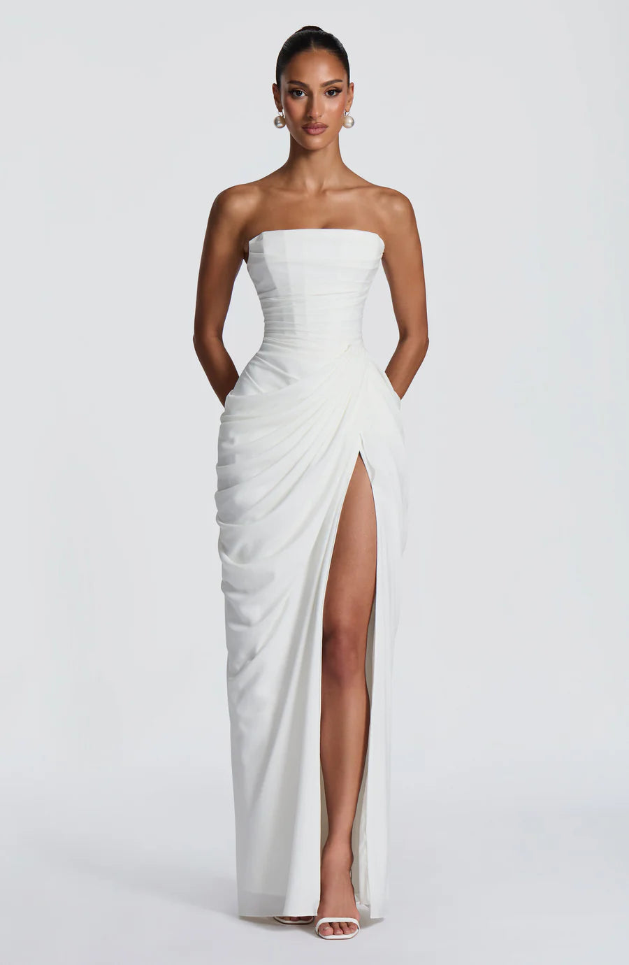 Strapless white ruched maxi dress with wrap skirt and high thigh slit, front full-length view