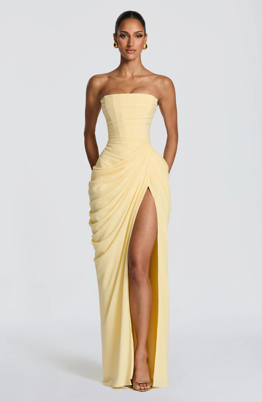 Yellow strapless ruched maxi dress with draped skirt and high thigh slit, full front view