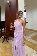 Purple halter neck maxi dress with layered ruffles, posed indoors holding a drink at an event setting