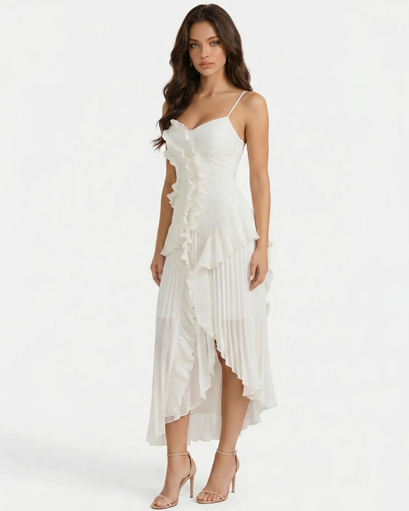 Three-quarter view of white maxi dress with cascading front ruffles and asymmetric pleated hem