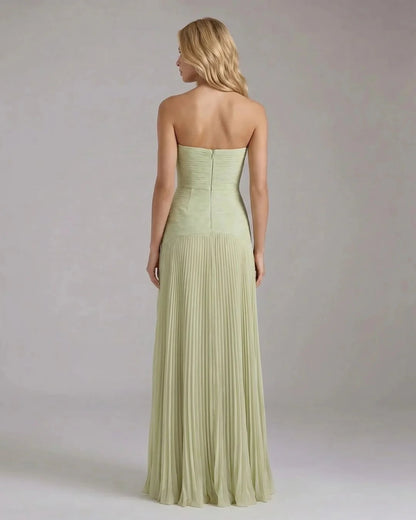 Back view of sage green strapless maxi dress with center zipper and pleated floor-length skirt