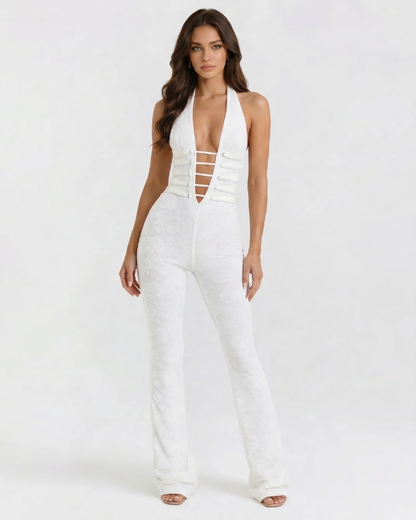 Angled front view of white corset jumpsuit, halter neck and deep V with horizontal strap cutouts, long legs