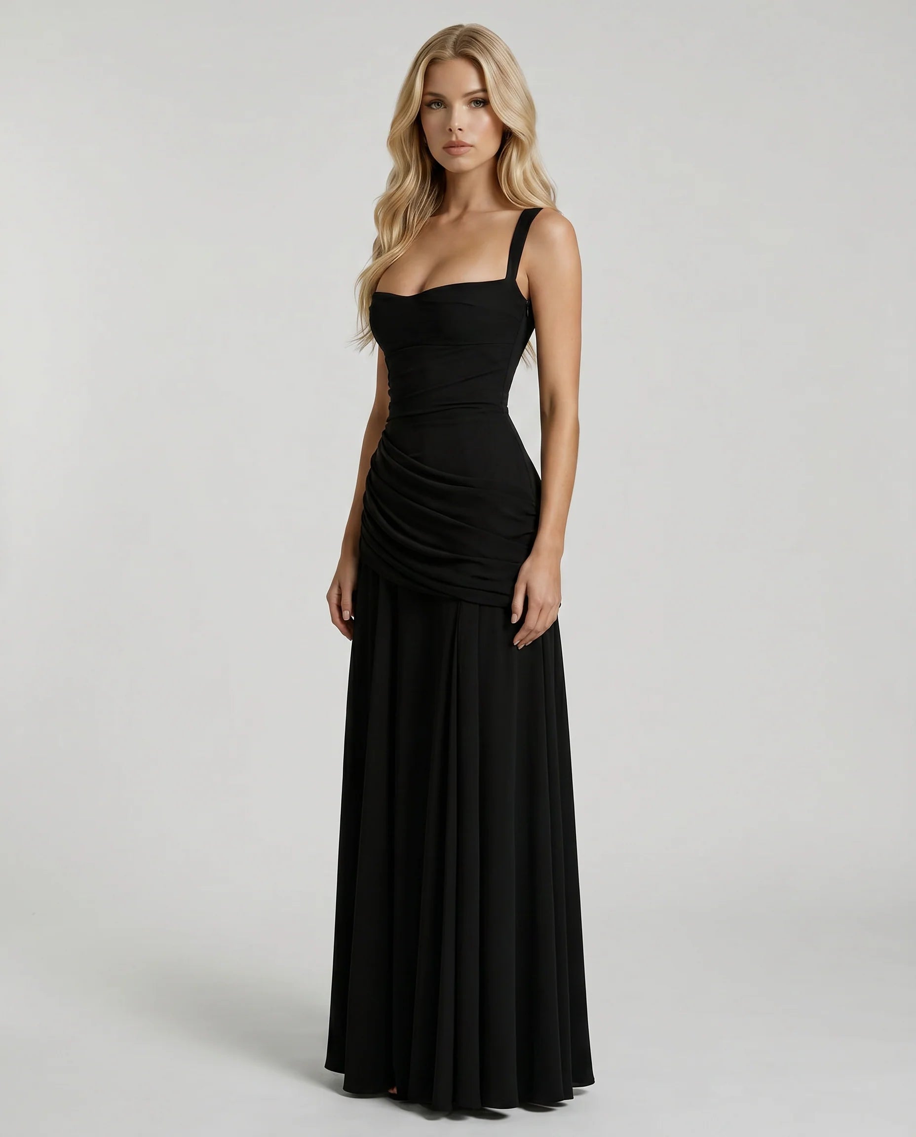 Side view of black ruched maxi dress with fitted bodice, wide straps, and flowing hem