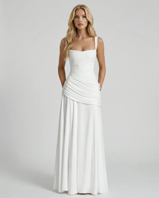 Front view white maxi dress showing draped ruching at hips and flared skirt
