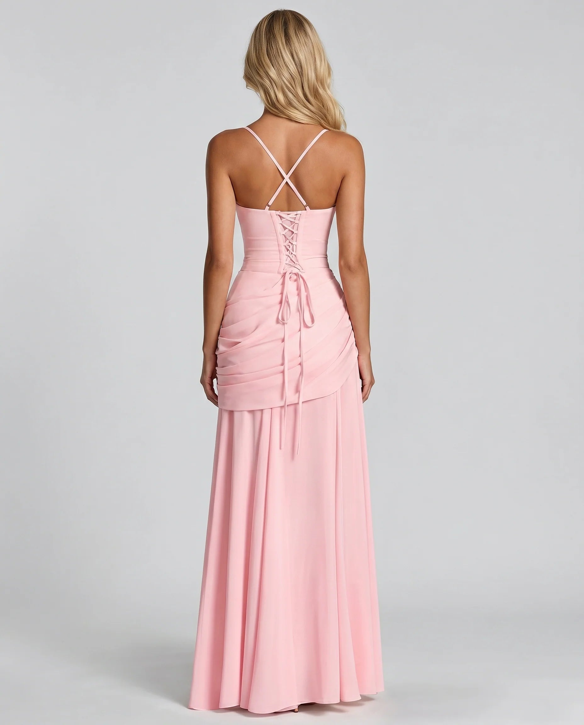 Back view of pink ruched maxi dress with crisscross straps and lace-up corset back detail