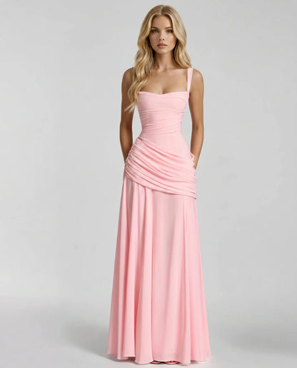 Front view of blush pink ruched maxi dress with square neckline, wide straps, and draped skirt