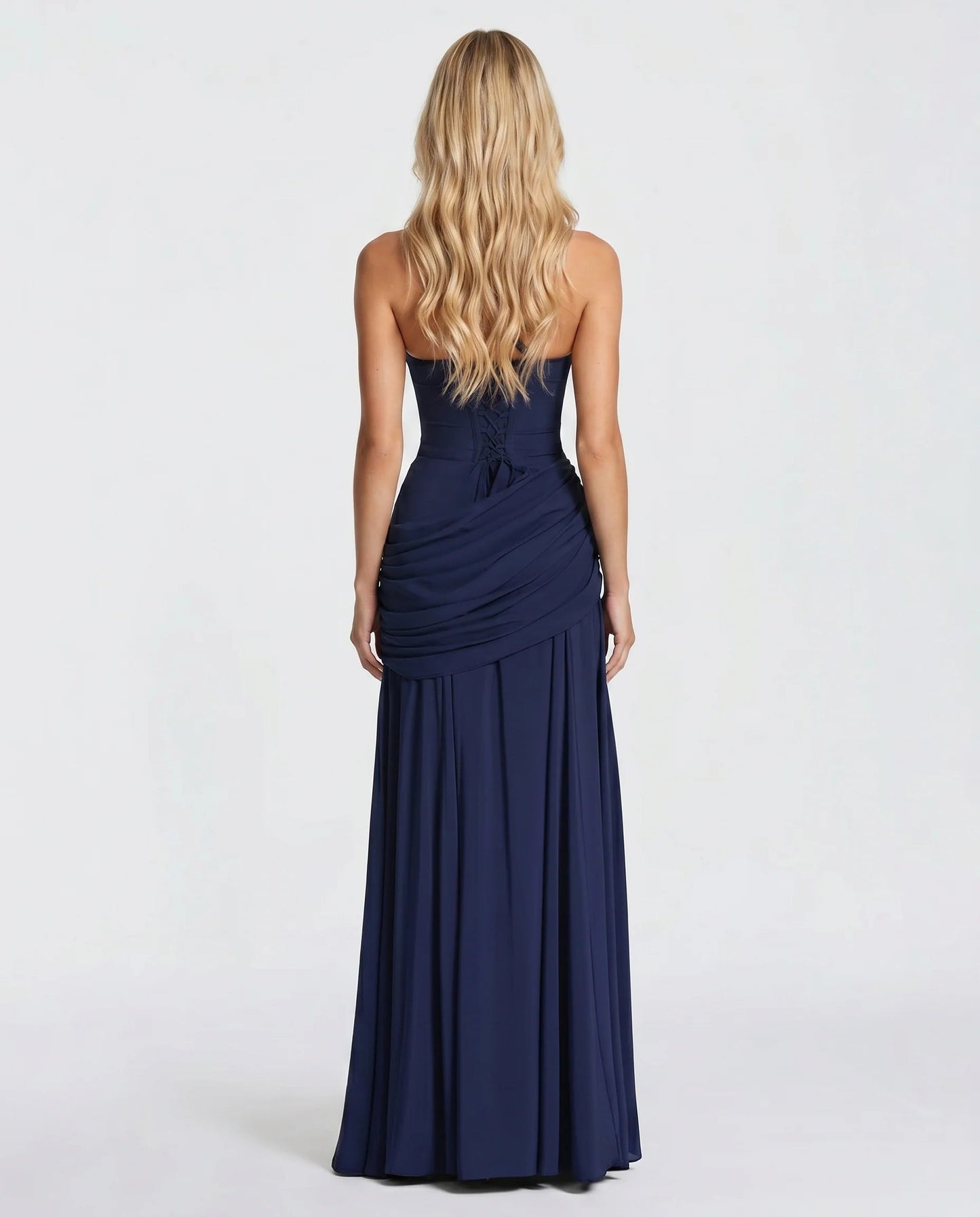 Back view of navy ruched maxi dress showing lace-up corset back and draped ruching
