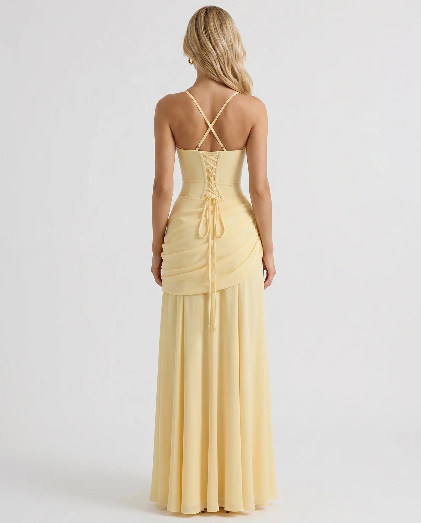 Back view of yellow ruched maxi dress with crisscross straps and lace-up corset detail at center back