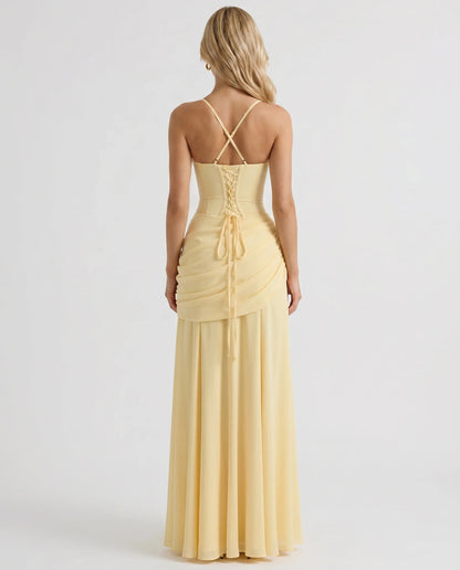Back view of yellow ruched maxi dress with crisscross straps and lace-up corset detail at center back