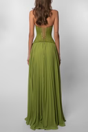 Studio back view of green corset maxi dress with open back bodice and full flowing skirt