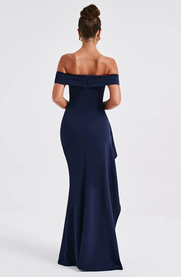 Back view navy off-shoulder maxi dress showing fitted bodice, concealed zip, and sweeping skirt