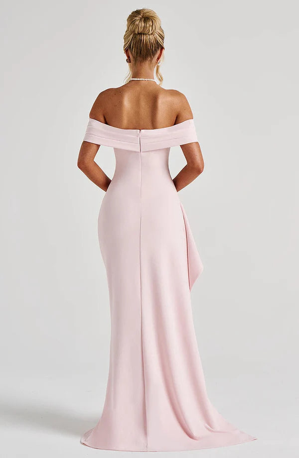 Back view of light pink off shoulder maxi dress with fitted bodice, zipper seam, and train