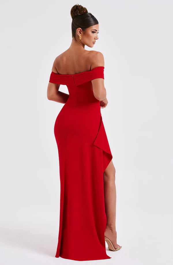 Back view of red off-shoulder maxi dress with ruched fit and long hemline, showing side drape