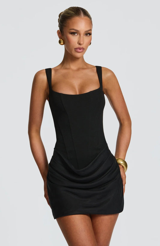 Front view black corset mini dress with square neckline, wide straps, and draped ruched skirt