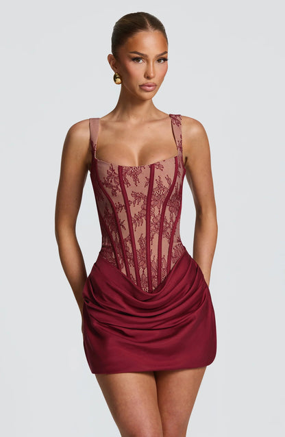 Burgundy lace corset mini dress with sheer mesh boned bodice and draped satin skirt, front view