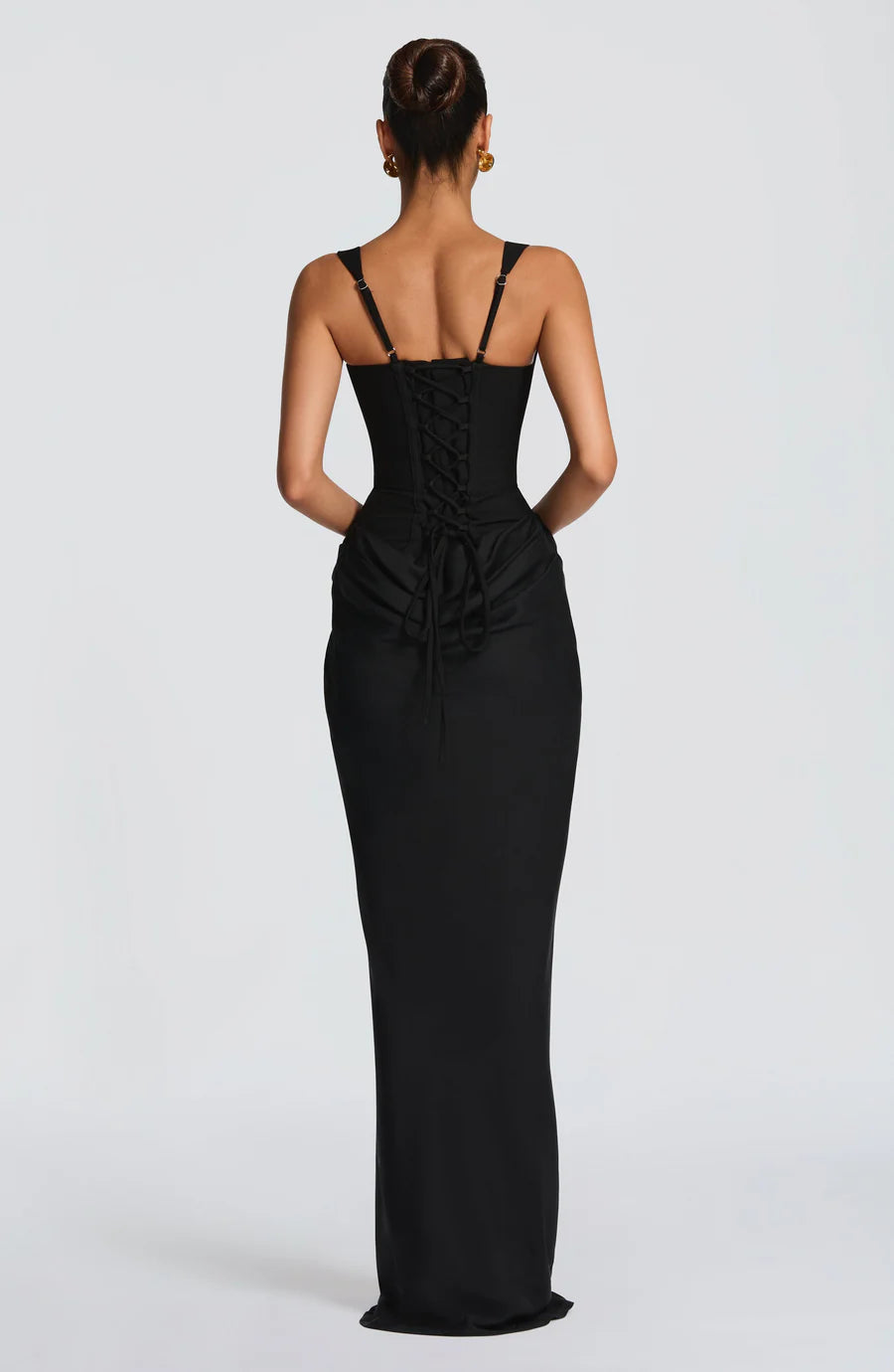 Back view of black maxi dress showing lace-up corset back, adjustable straps, and floor-length skirt