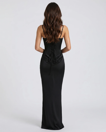 Back view of black draped maxi dress with lace-up corset back, slim straps and floor-length skirt