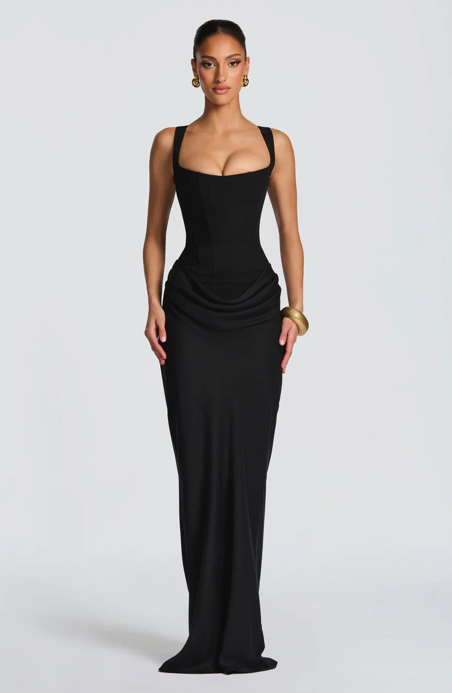 Black draped maxi dress with square neckline, wide straps, fitted bodice, and hip drape detail