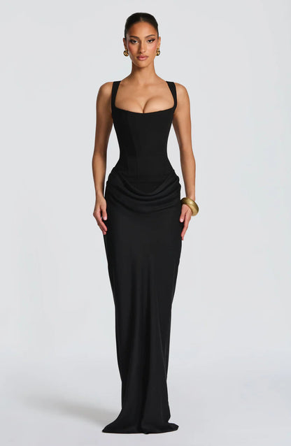 Black draped maxi dress with square neckline, wide straps, fitted bodice, and hip drape detail