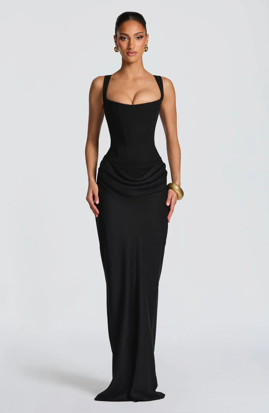 Black draped maxi dress with square neckline, wide straps, fitted bodice, and hip drape detail