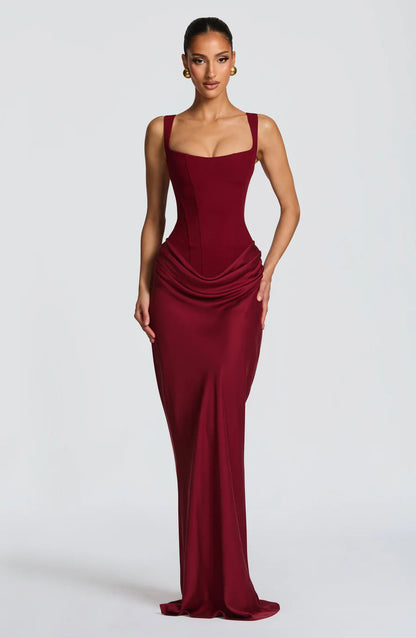 Burgundy draped maxi dress with square neckline, fitted corset bodice and floor-length skirt