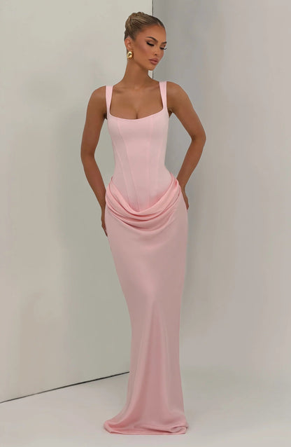 Lifestyle full-length blush pink draped maxi dress with square neck and fitted silhouette