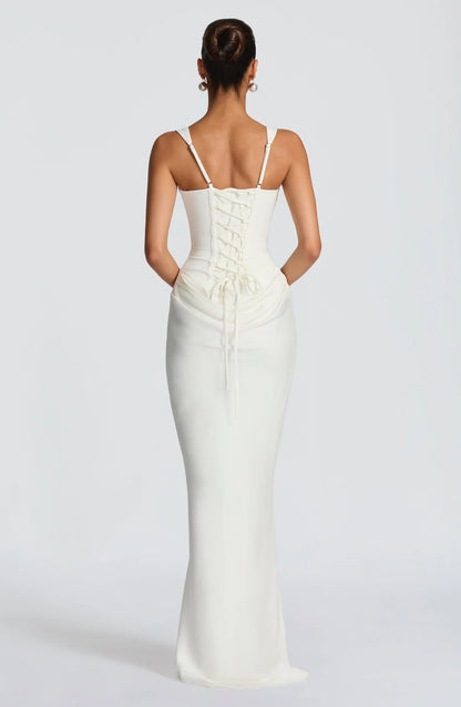 Back view of white draped maxi dress with adjustable straps, lace-up corset back and gathered detail