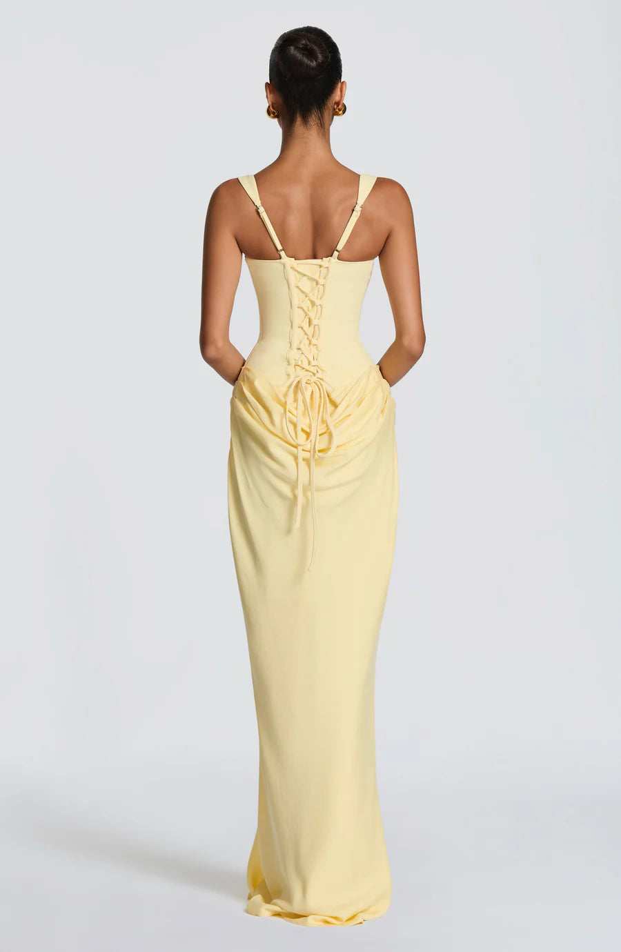 Back view of yellow draped maxi dress with lace-up corset back and adjustable shoulder straps