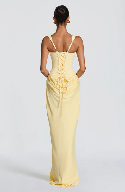 Back view of yellow draped maxi dress with lace-up corset back and adjustable shoulder straps